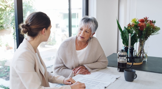 older woman speaking to younger woman
