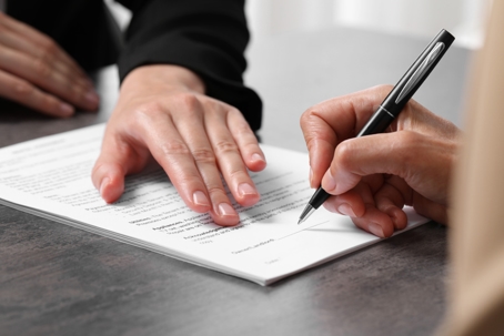 person signing a document