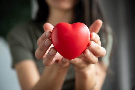 woman holding heart figurine