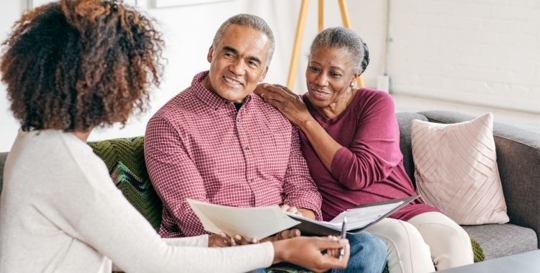 couple sitting with estate planning attorney