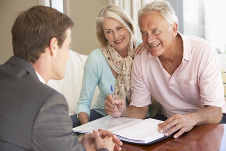 two older clients smiling with estate planning attorney