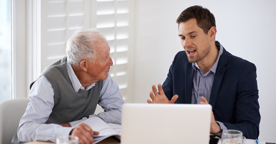 older man speaking with attorney about trusts