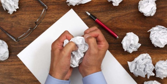 person crumpling up paper